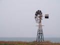 Antique wind mill by the sea Royalty Free Stock Photo