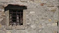 Antique window in stone wall Royalty Free Stock Photo