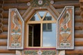 Antique window frames and balcony decorated with flowers.