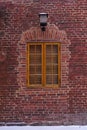 Antique window with yellow wooden frames on a red brick wall Royalty Free Stock Photo