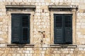 antique windows with closed shutters in a wall