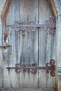 Antique wood front doors with wrought iron hinges Royalty Free Stock Photo