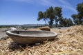 Antique wooden bowl lying on golden straw in the ancient city of Zipori. Israel.