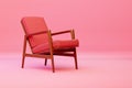 an old chair in pink, with a wood frame and cushion on top Royalty Free Stock Photo