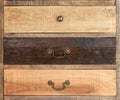 An antique wooden chest of drawers with metal handles, different kind old wooden boxes Royalty Free Stock Photo