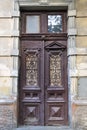 Antique wooden door with forged window frames