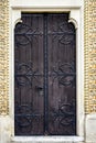 Antique wooden door decorated with wrought iron decorative elements