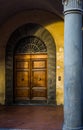 Antique wooden door in a Pisa street. Tuscany, Italy.