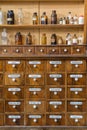 Antique Wooden Drawers of a Chemistry Laboratory and Glass Bottles