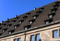 Antique wooden framed window on stone roof, Europe