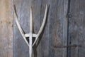 antique wooden pitchfork leaning on barn door Royalty Free Stock Photo