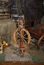 Antique wooden spinning wheel with a spindle on a hay background Royalty Free Stock Photo