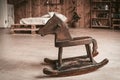 Antique wooden toy horse on the floor of spacious bedroom. Happy childhood memories concept Royalty Free Stock Photo