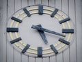 Antique wooden wall clock, installed on the old building wall. Royalty Free Stock Photo