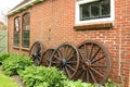 Antique wooden wheels against an old wall