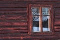 Antique wooden window with white painted window frame on the wall of historical blockhouse in northern Slovakia.
