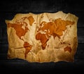 antique-world-map-black-wooden-background-151672713.jpg