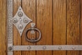 Antique wrought iron door handle on a wooden door close-up Royalty Free Stock Photo