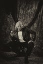 Antiqued steampunk portrait of man sitting in studio