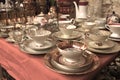 Antiques on flea market or festival - vintage porcelain tea cups, tableware and other vintage things. Collectibles