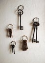 Antiques iron keys hanging on a house whitewashed wall