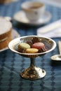 Antiques silver candy pedestal with chocolates and macarons stillife Royalty Free Stock Photo