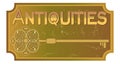 Antiquities signboard in old metal design with ancient key, ancient patinated brass