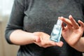 Antiseptic is squeezed out on the hands. COVID-19 Close up woman hands using wash hand sanitizer gel dispenser, against Novel Royalty Free Stock Photo