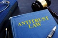 Antitrust law book and gavel on a desk.