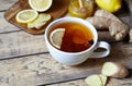 Antiviral ginger tea with lemon and honey on wooden background. Healthy drink. Rustic style. Creative composition. Royalty Free Stock Photo