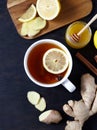 Antiviral healthy ginger tea with lemon and honey on dark background. Top view. Useful drink