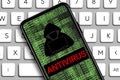 antivirus word and Hacker icon in mobile phone with digital code numbers Royalty Free Stock Photo