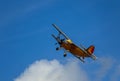 Antonov AN-2 biplane fly on cloudy sky. Old yellow historic plane from side Royalty Free Stock Photo