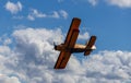 Antonov AN-2 biplane fly on cloudy sky. Old yellow historic plane from side bottom