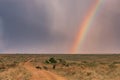 Rainbow sunrays bursting into clouds wildlife animals grazing on the savannah grasslands at the Maasai Mara National Game Reserve