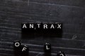 Antrax on wooden cubes. On table background