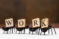 Ants carry letters that make up the word work Royalty Free Stock Photo