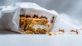 Ants invading a sweet cookie bar with cream inside a torn plastic bag, finding crumbs of food Royalty Free Stock Photo
