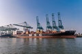 Antwerp Belgium August 2019, harbor of Antwerpen with container vessel and oil raffin and tanks