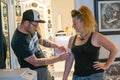 A male tattoo master at work with his client Royalty Free Stock Photo