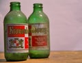 Close-up and detail of two vintage and dusty green colored Kronenbourg beer bottles