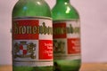 Close-up and detail of two vintage and dusty green colored Kronenbourgh beer bottles