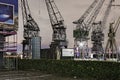 Antwerp, Belgium - February 5, 2020: Old loading cranes on the banks of the river Scheldt in the Antwerp harbor.