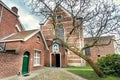 Green courtyard of monastery in historical city area, 13th century Beguinage houses for beguines women Royalty Free Stock Photo