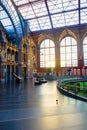 Antwerp, Belgium - June 2019: Interior of Antwerp Central Train station with sun shining through the glass windows