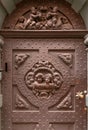 Angels on metal door, small sculptures on facade of historical home