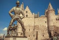 Giant figur of Lange Wapper, funny Flemish folkloric character and Medieval fortress Het Steen with brick walls