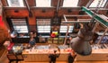 Top view on counter with beer drinking people inside historical brewery with trademark De Koninck