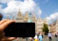 Antwerp, Flanders, Belgium. August 2019. In the town hall square, a smartphone frames the magnificent Renaissance buildings: the Royalty Free Stock Photo