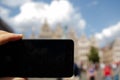Antwerp, Flanders, Belgium. August 2019. In the town hall square, a smartphone frames the magnificent Renaissance buildings: the Royalty Free Stock Photo